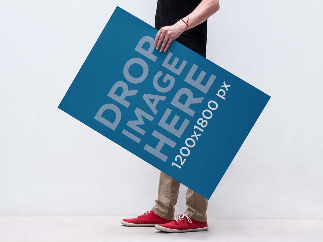 Free PSD of a Man Holding a Poster Mockup
