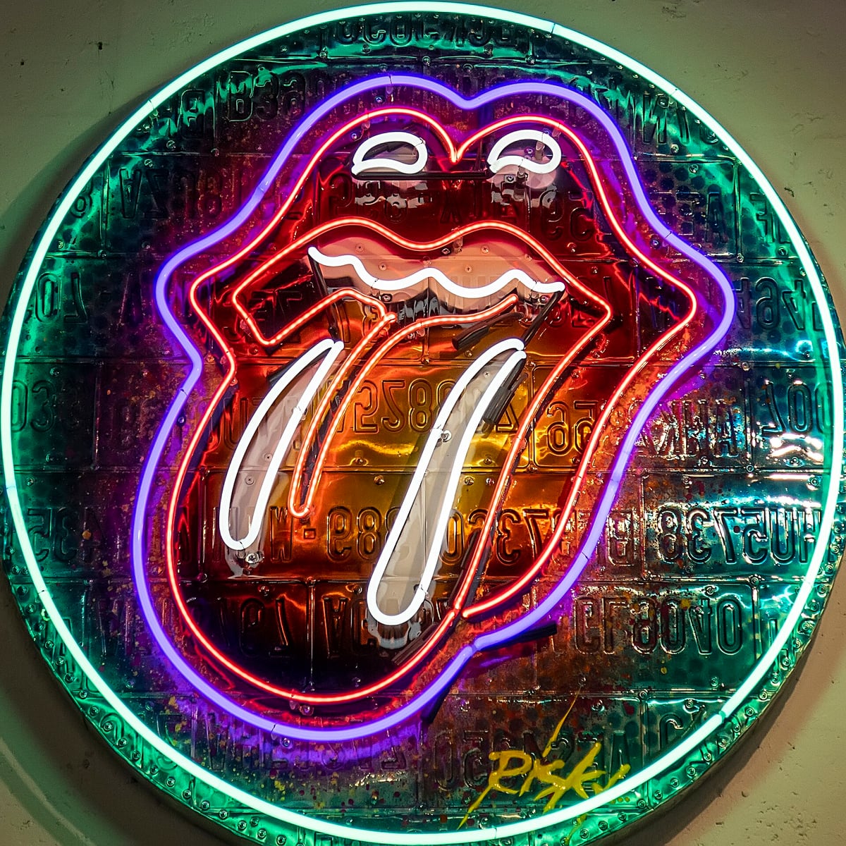 Neon sign version of the Rolling Stones tongue and lips logo in red, white and purple tubes inside a green neon circle